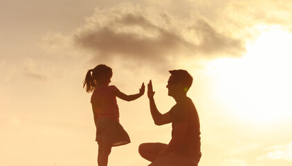 Father giving daughter high five. Parent child relationship concept.   Family support, trust together,  bonding in nature,  fatherhood, childhood concept 