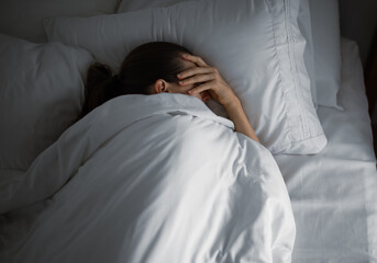 sad depressed tired woman home alone in her bed can't sleep
