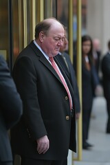 Man in Suit Standing Outside Building