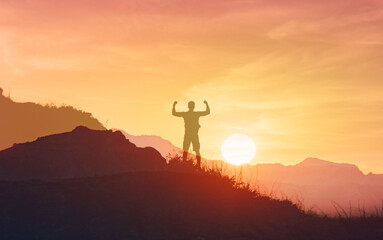 Silhouette of a champion on mountain top. Travel and adventure. Mountain hiking. Mountains during...