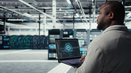 Software developer in data center uses AI technology on laptop to optimize storage volumes. IT expert in server hub facility using artificial intelligence to ensure seamless operations, camera A - Powered by Adobe