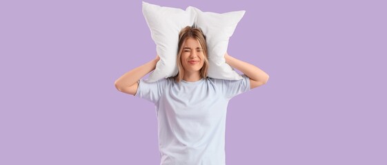 Young woman plugging ears with pillow while suffering from loud noise on lilac background