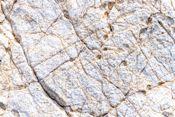 Abstract macro closeup of white rock stone pattern with salt texture by sea in Dionysus cave by Iero beach on Ikaria island, Greece