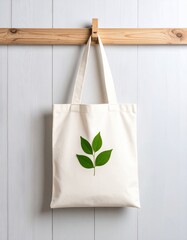 Canvas Tote Bag with Green Leaf Design Hanging on Wooden Wall
