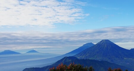 Fototapeta premium blue mountain peak with clouds and clear sky