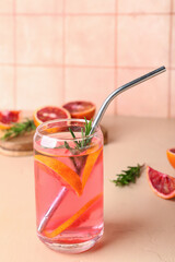 Glass of tasty blood orange lemonade on table
