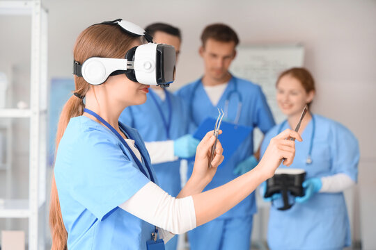 Female doctor with surgical instruments using VR glasses in clinic