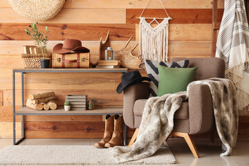 Interior of living room with armchair, shelf unit and cowboy hat