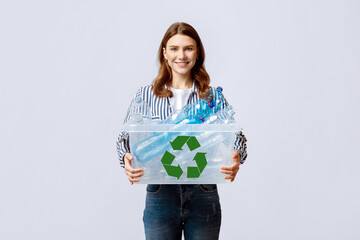 Waste Reuse. Cheerful Young Woman Carrying Container With Plastic Bottles For Recycling And Smiling...