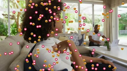 after two seconds woman leaning, man typing as social media hearts drifting around them on sofa - Powered by Adobe