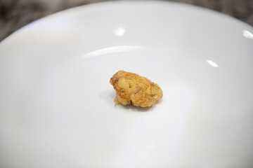 Cooked rainbow trout fish roe eggs wildcaught food from Colorado freshwater lake fried on white plate macro closeup