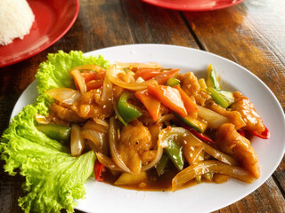 Sweet and sour chicken close up background. Stock photo.