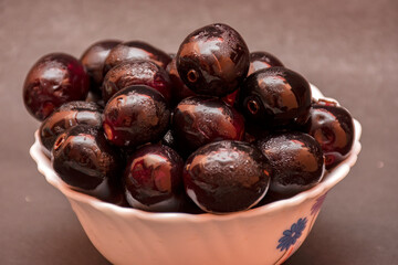 Fresh Organic Black Currants in a Small Bowl on White Background