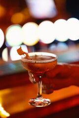 Cocktail in hand at the bar