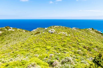 Gordijnen Drakano tower hiking trail path footpath landscape picturesque view on Ikarian Sea at Greek Aegean islands region of Ikaria island, Greece © Andriy Blokhin