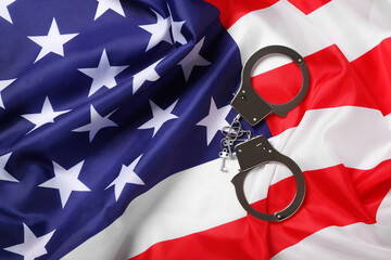 USA flag and handcuffs, top view