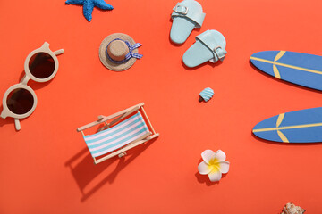 Summer composition with decorative beach accessories on red background
