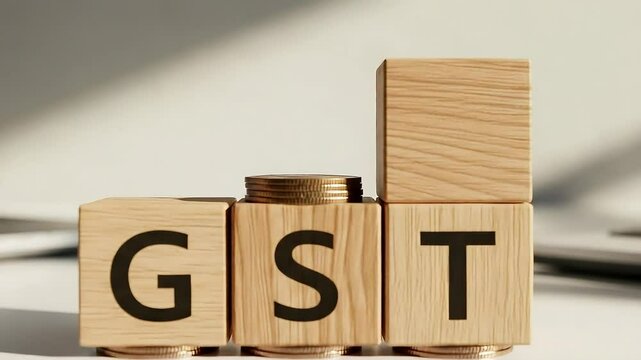 GST Concept: Wooden Blocks, Coins, and Rising Tax Rates on White Surface