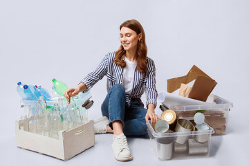 Portrait Of Young Woman Sitting Among Containers With Sorted Garbage, Millennial Smiling Lady...