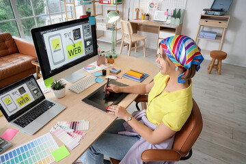 Beautiful web designer working with graphic tablet at table in office
