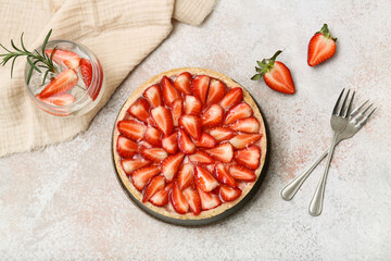 Plate with sweet strawberry tart and glass of infused water on white background