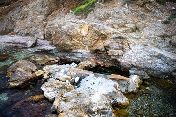 Agia Kyriaki thermal hot springs at Almyrida, Ikaria island, Greece fishing village Greek radioactive radon water, longevity blue zone
