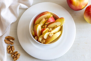 Healthy vegetarian Salad with apples, walnuts and honey in bowl. Top view