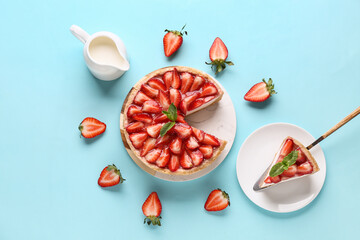 Cut sweet strawberry tart with mint and jug of fresh milk on blue background