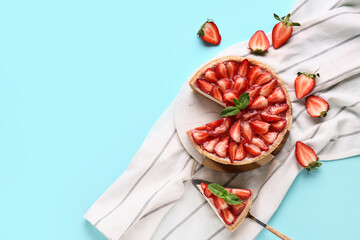 Cut sweet strawberry tart with mint on blue background