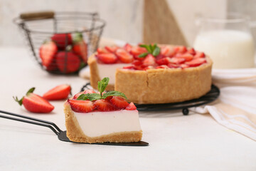 Spatula with piece of sweet strawberry tart on white background