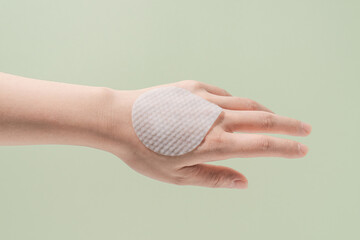 Hand with Skincare Cotton Pad on Back – Minimal Beauty Concept