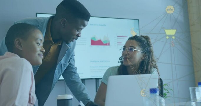 Man leaning over table pointing at graphs on display guiding business team analyzing sales trends