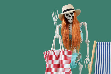 Human skeleton with wig and beach accessories on green background. Summer vacation concept