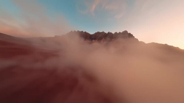 Breathtaking Aerial View of a Majestic Mountain Range with Soft Clouds