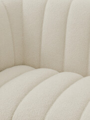 Close-up of ivory boucle chair upholstery, soft neutral textures, aesthetic editorial interior photography for social media faceless digital content marketing

