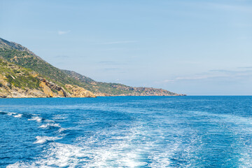 Coast coastline of Ikaria island, Greece Aegean Ikarian sea of Mediterranean in longevity blue zone and azure blue water from ferry near Therma
