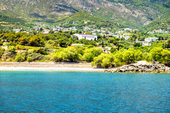 Agios Kirykos blue water at Icarian sea on Ikaria, Greece Greek blue zone island with beach and houses buildings up hill
