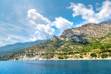 South of Ikaria island, Greece dramatic landscape of coastal Greek mountains in blue sky and...