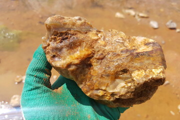 Flint boulder with veins of quartz and chalcedony, search for stone-cutting raw materials in a...