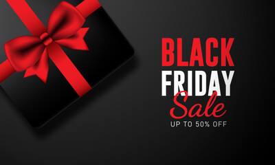 Black Friday Sale Text and black gift box with red ribbon bow On Black Background . Suitable For Black Friday Business Holiday