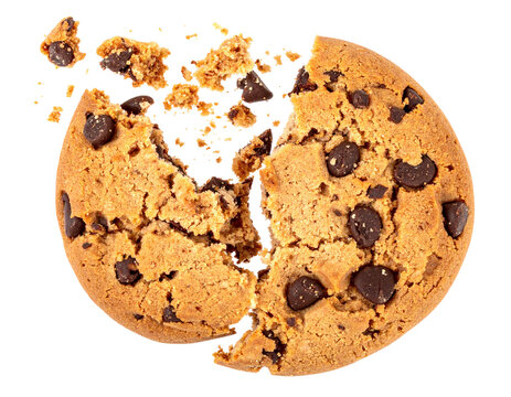 A split chocolate chip cookie with crumbs scattered around