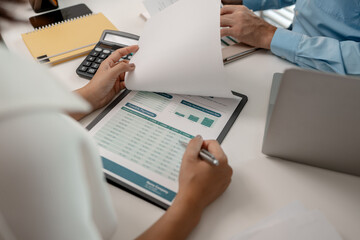 Fototapeta premium the company's statistics department staff is checking the figures form the graph in the document for recording, accounting, finance, marketing, entrepreneur, paperwork, office