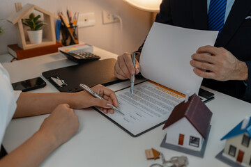 staff is explaining the information about the house lease contract documents to the buyer, the...