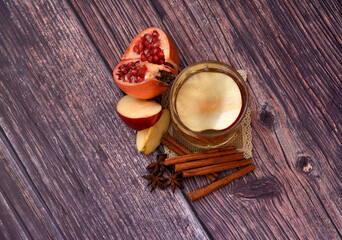 Cider with pomegranate, strong alcohol with a crystal glass on a wooden table, anise poison,...