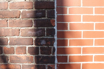 Brick wall background with old and new bricks. Contrast between old and new. Construction industry...