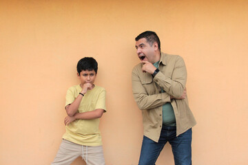 Single dad enjoys playing with his 10-year-old dark-skinned Latino son and spending time together...