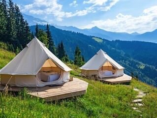 Two cozy glamping tents nestled in a grassy mountain meadow
