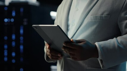 IT professional in server hub ensuring valuable data remains shielded from potential threats using tablet. Worker safeguarding data center against unauthorized access and vulnerabilities, camera B - Powered by Adobe