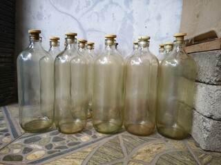 A collection of empty transparent glass bottles.this type of bottle is commonly used for gasoline,