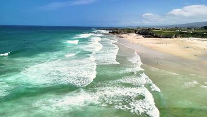The breathtaking coastal scenery showcases stunning turquoise waters and golden sands, all under a...